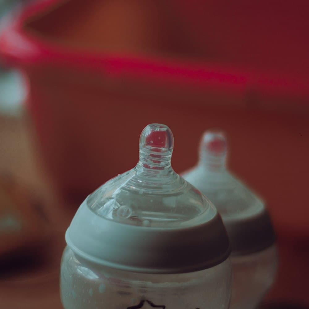 A baby feeding bottle on a plain surface