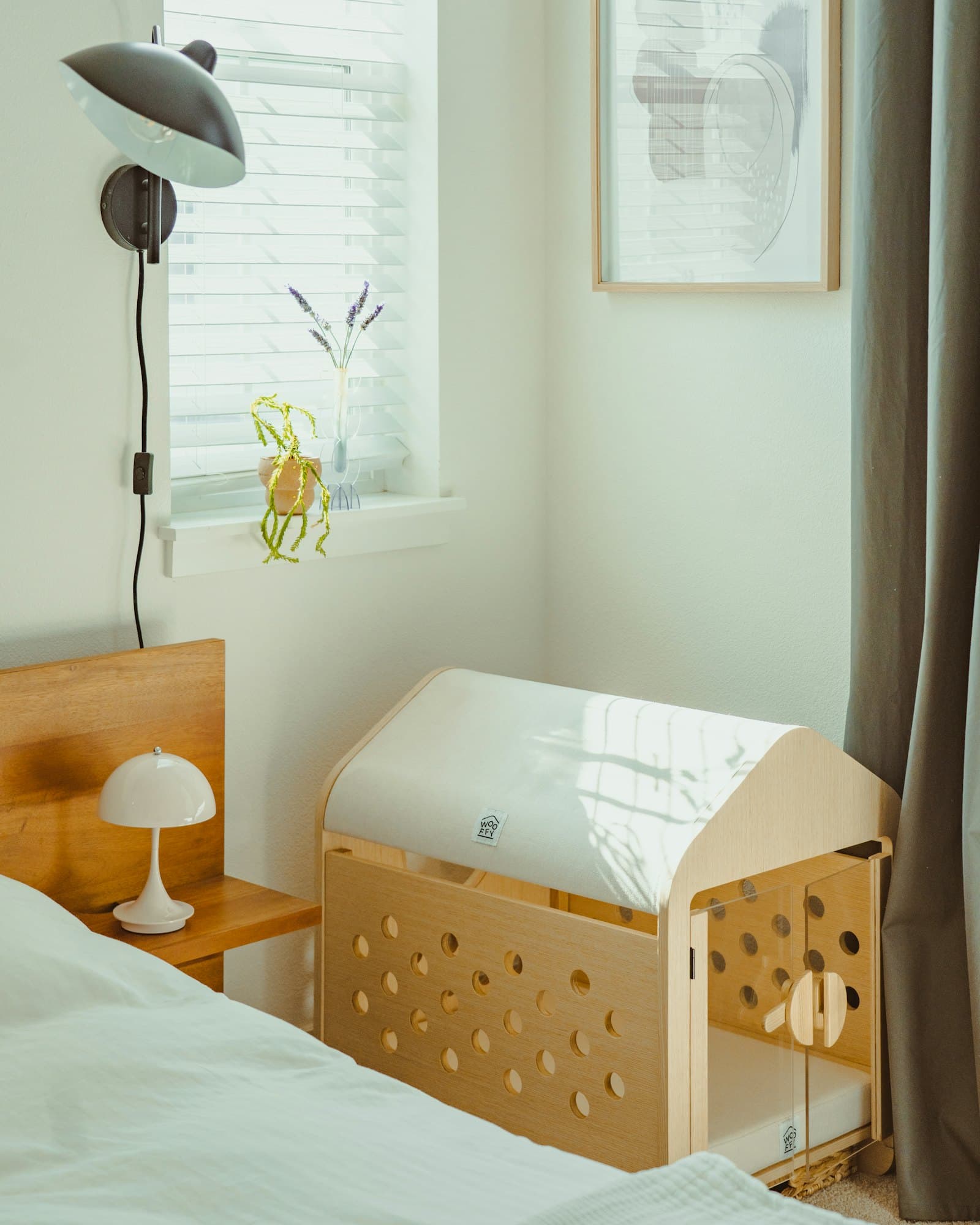 A child's room with a cot made up beside a chest of drawers